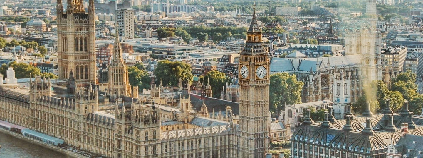 London_2020_1450x540.jpg Aerial view of Big Ben clock tower and the Houses of Parliament in the city of London in England, United Kingdom.